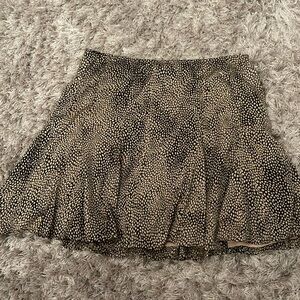 Beige and black mini skirt. Tight on waist but flowy.